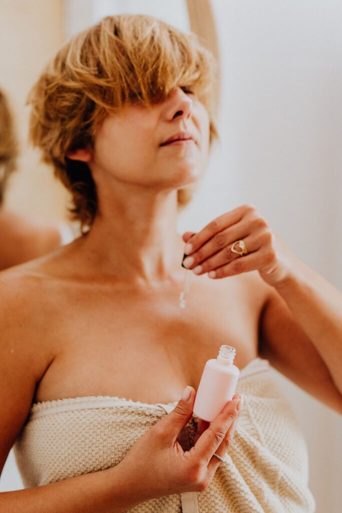 Mulher aplicando sérum antioxidante com conta-gotas no rosto