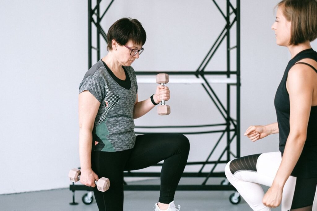 mulher madura fazendo musculação com orientação, hábito que ajuda a pele na menopausa