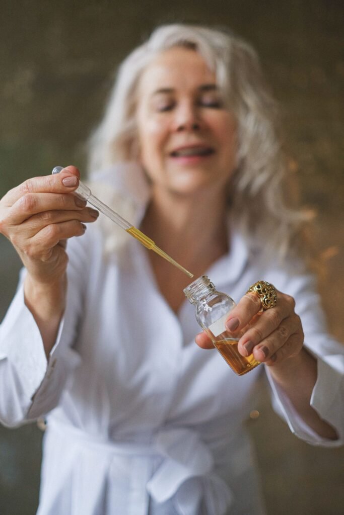 Mulher madura segurando conta-gotas de sérum